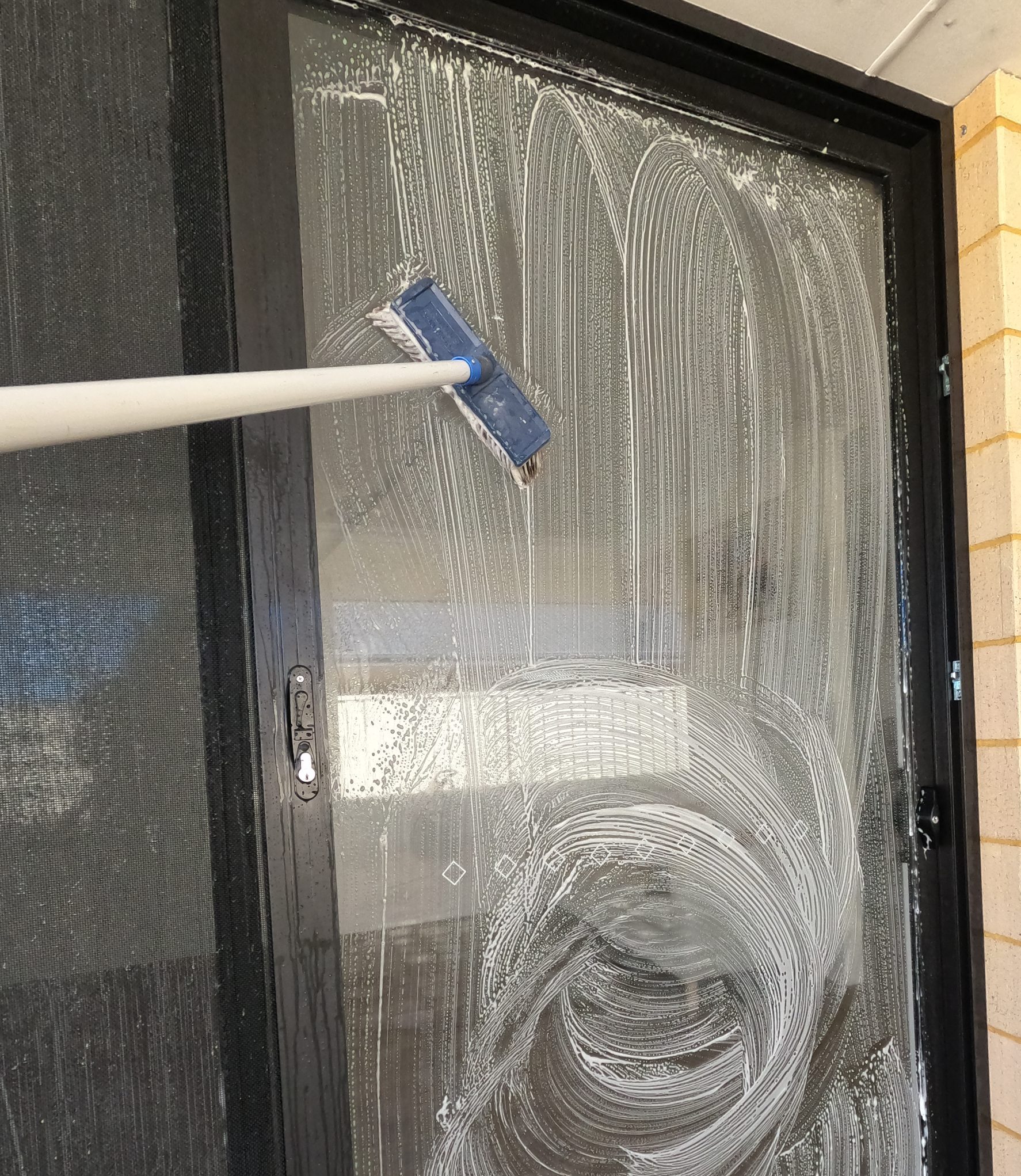 Scrubbing Window and frames before Pressure cleaning