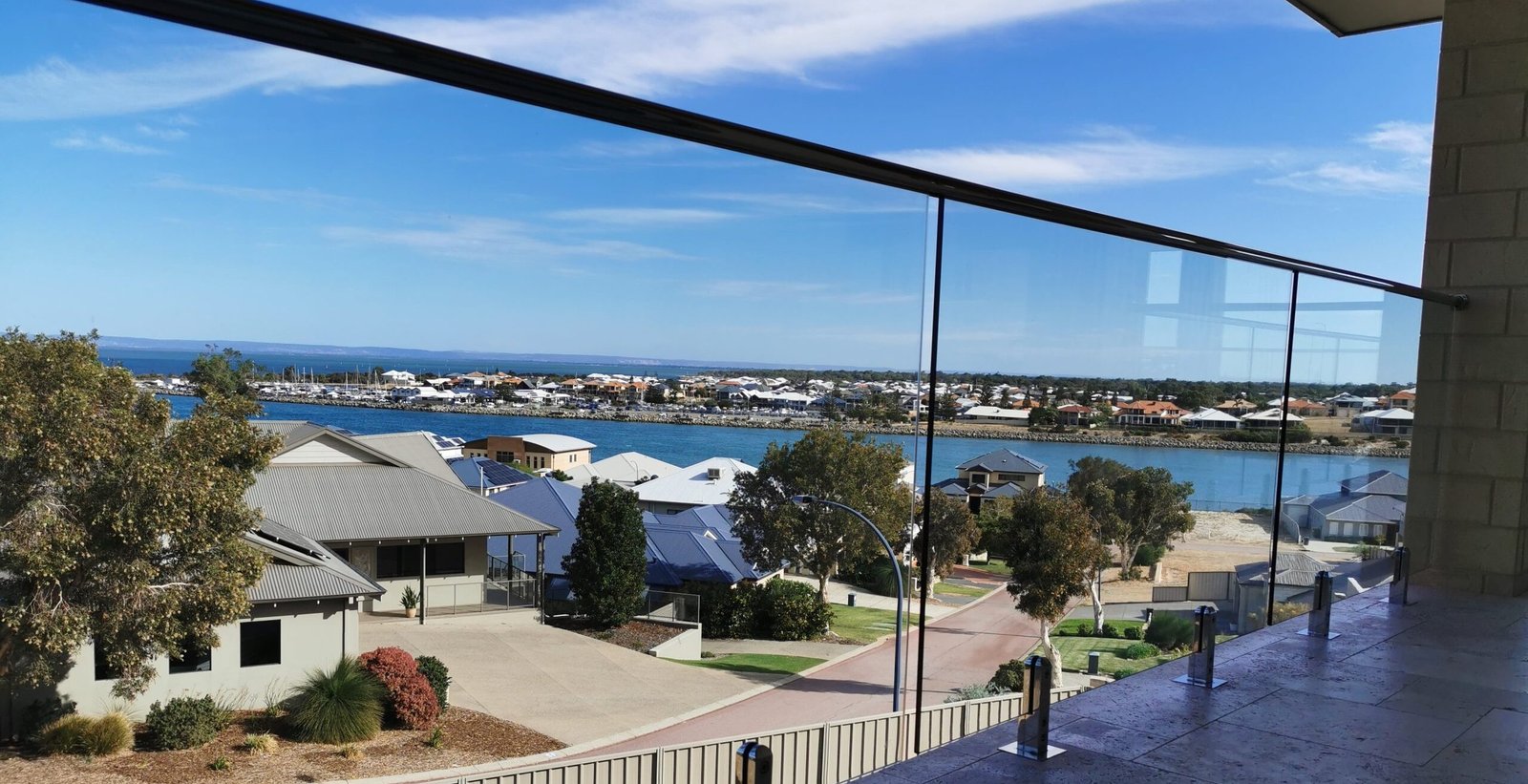Clear glass balustrade overlooking Mandurah waterways, photographed on a Seaside Suds job