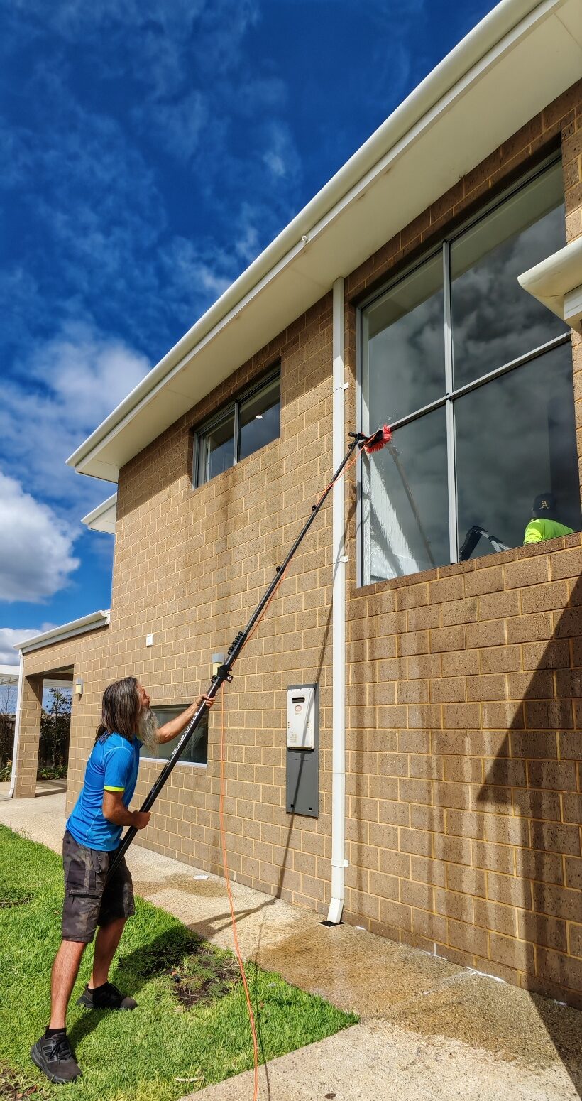 Taron on long pole cleaning secvond story windows in mandurah